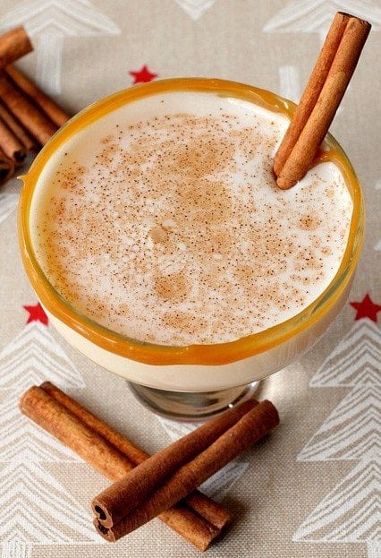 eggnog-cocktail Eggnog cocktail served in a caramel rimmed glasses sprinkled with cinnamon powder on top.