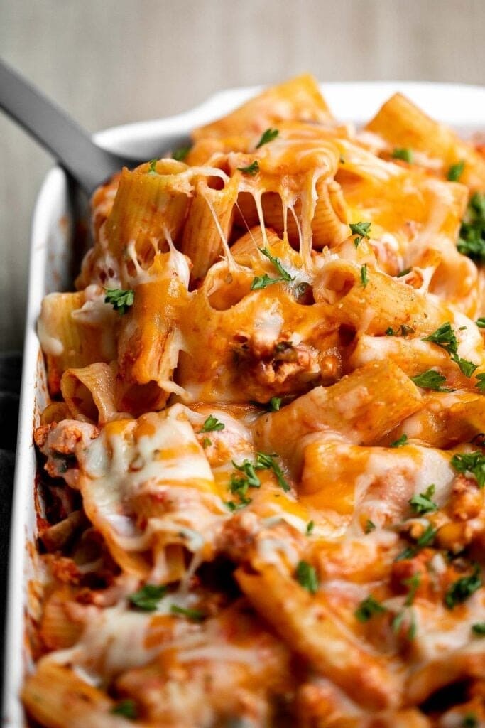 Cheesy ground turkey pasta bake on a baking dish.