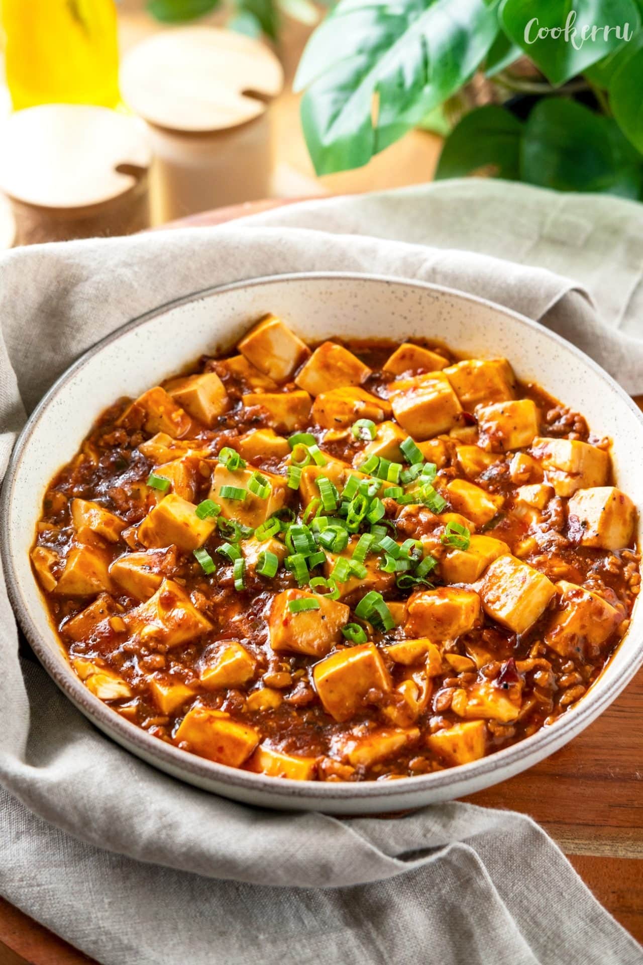 Bowl of Mapo tofu with spicy bean paste and dried chili.