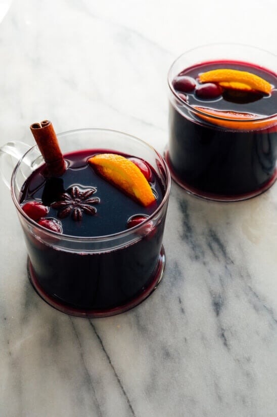mulled-wine Mulled wine in glasses garnished with berries, slices of lemon, cinnamon stick and star anise.