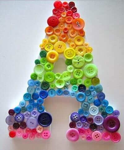 A letter 'R' covered in a rainbow of buttons.
