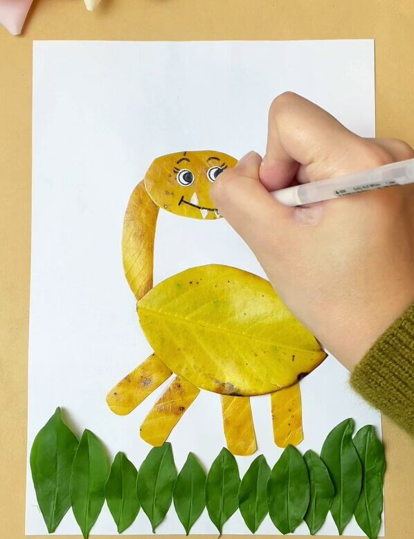 Completing the Facial Features of the Dinosaur- A Tutorial for Kids - How To Put Together a Dinosaur Animal Craft with Leaves