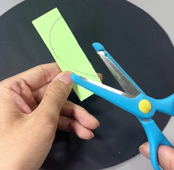 Cutting Drop Shape Out Of Paper - Making a paper cactus as a fun activity for kids.