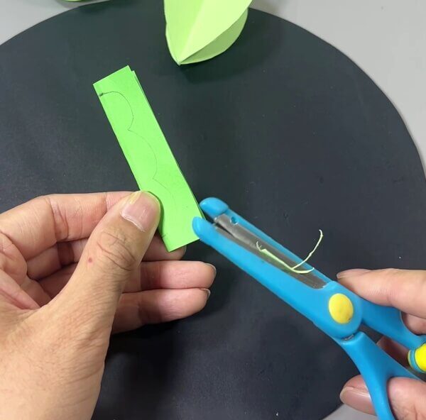 Cutting Cactus Leaves Out Of Green Paper - Get creative with paper cacti and the kids.