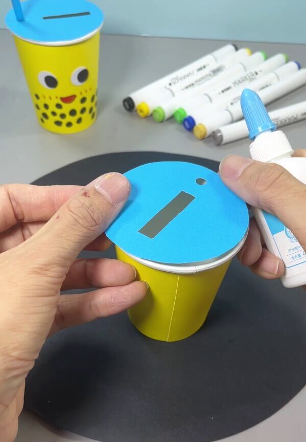 Pasting Circle On Paper Cup - Create your own customized mug craft with this straightforward project.