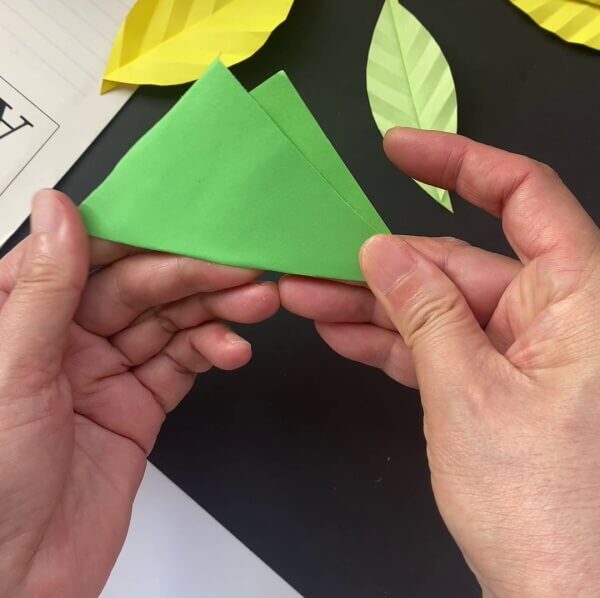 Folding The Green Paper In Mountain Shape A step-by-step guide to teaching kids to fold a paper leaf