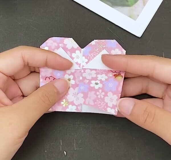 Turning The Folds Backward- Here is a step-by-step guide on how to make an Origami Heart Envelope.