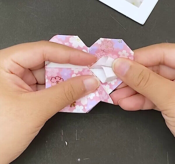 Working On The Triangles In The Middle- The steps to making an Origami Heart Envelope are outlined in this tutorial.