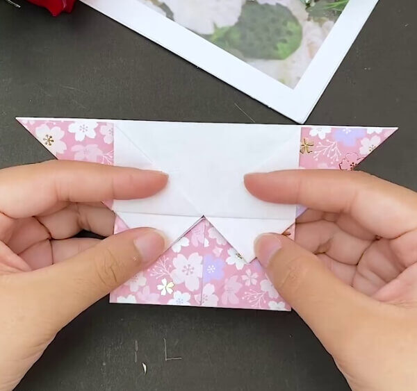 Flattening The Triangular Folds Downwards- Mastering the art of origami to make a heart-shaped envelope