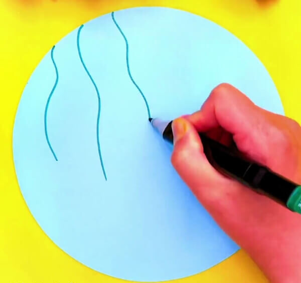 Drawing The Stems Of The Flowers On Blue Paper-Teach children how to construct clay butterflies and blossoms