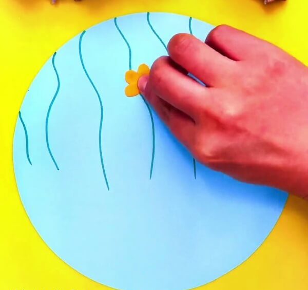 Make A Flower With Orange Modelling Clay-Instructing youngsters in the art of creating clay butterflies and flowers