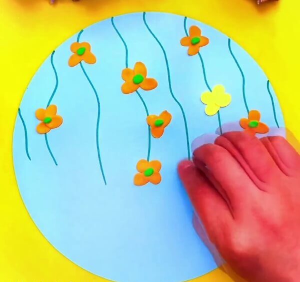 Keep On Making Flowers With Orange And Yellow Modelling Clay-Educate kids on how to form clay butterflies and blooms